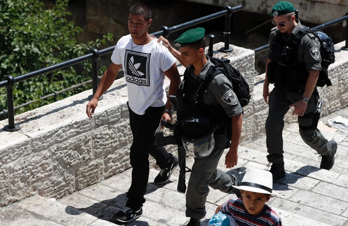 Israeli borderguards detain a Palestinian man outside Damascus Gate in Jerusalem’s Old City on June 18, 2017. (AFP )