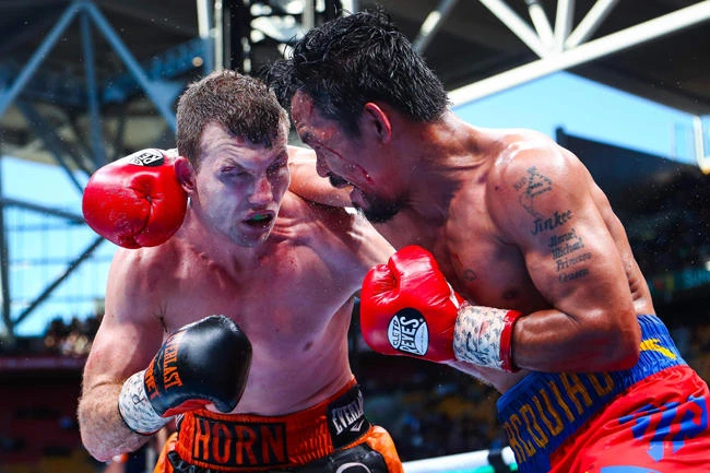 Manny Pacquiao (R) and Jeff Horn butt it out during their World Boxing Organization bout at Suncorp Stadium in Brisbane, Australia, on Sunday. (AFP / AFP / Patrick Hamilton)