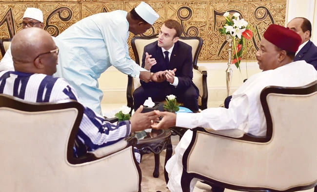 French President Emanuel Macron speaks with Chad’s leader Idriss Deby Itno as they gather with other dignitaries in Bamako, Mali, on Sunday. (Reuters)