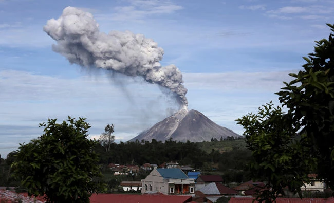 Mount Sinabung spews volcanic ash into the air, as seen from Berastagi, North Sumatra, Indonesia. (AP)