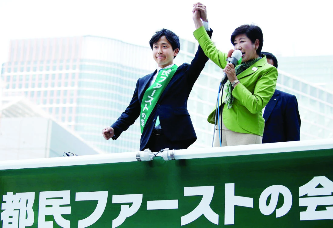 Tokyo governor and head of Tokyo Citizens First party, Yuriko Koike, right, delivers a speech to voters in Tokyo in this June 23 file photo. (Reuters)
