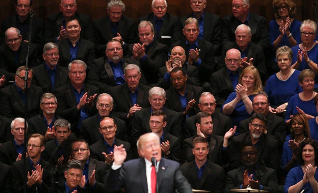 Members of the First Baptist Dallas Church Choir are seated behind US President Donald Trump, as he speaks during the Celebrate Freedom event at the Kennedy Center for the Performing Arts in Washington, Saturday. (AP)