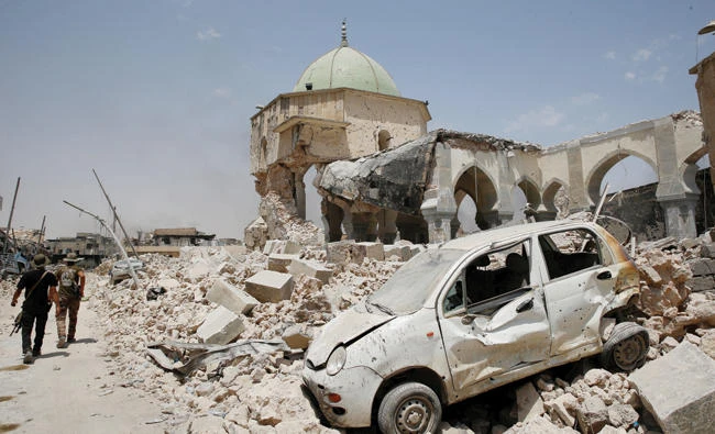 Iraqi soldiers walk past the Al-Nuri Mosque in Mosul's Old City on Sunday. (Reuters)