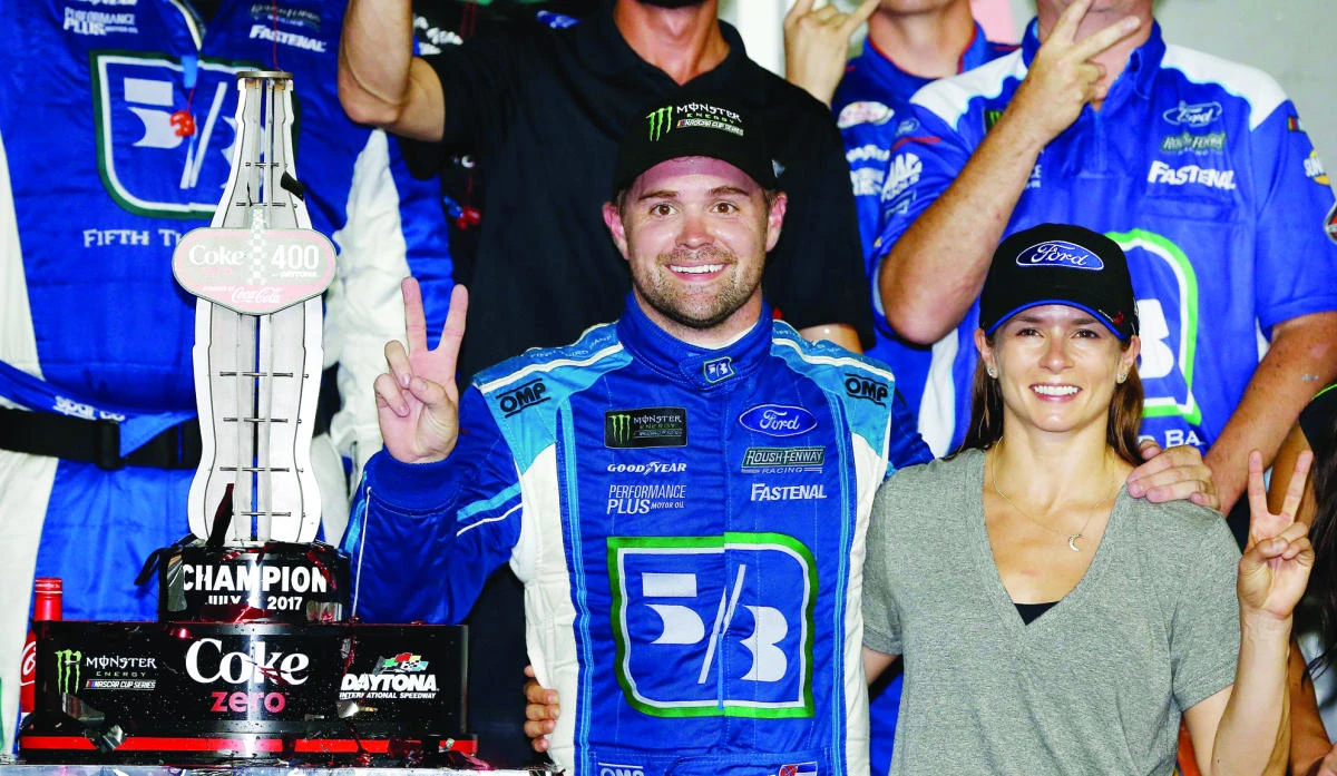 Ricky Stenhouse Jr., driver of the #17 Fifth Third Bank Ford, celebrates in Victory Lane with his girlfriend Danica Patrick, driver of the #10 Aspen Dental Ford, after winning the Monster Energy NASCAR Cup Series 59th Annual Coke Zero 400 Powered By Coca-Cola at Daytona International Speedway on Saturday in Daytona Beach, Florida. (AFP)