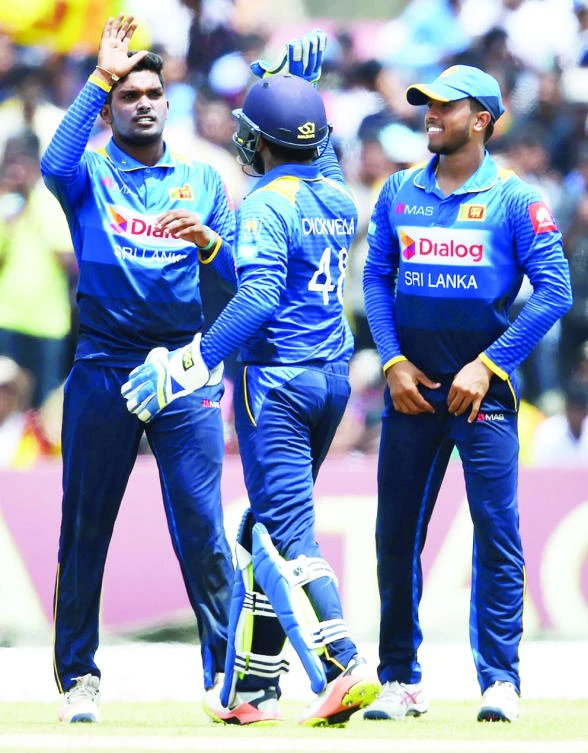 Wanidu Hasaranga, left, on his way to a hat trick on debut for Sri Lanka Sunday. (AFP)