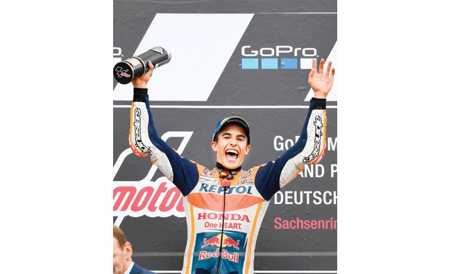 Spanish Honda rider Marc Marquez celebrates after winning the MotoGP competition of the Moto Grand Prix of Germany at the Sachsenring Circuit on Sunday in Hohenstein-Ernstthal, eastern Germany. (AFP)