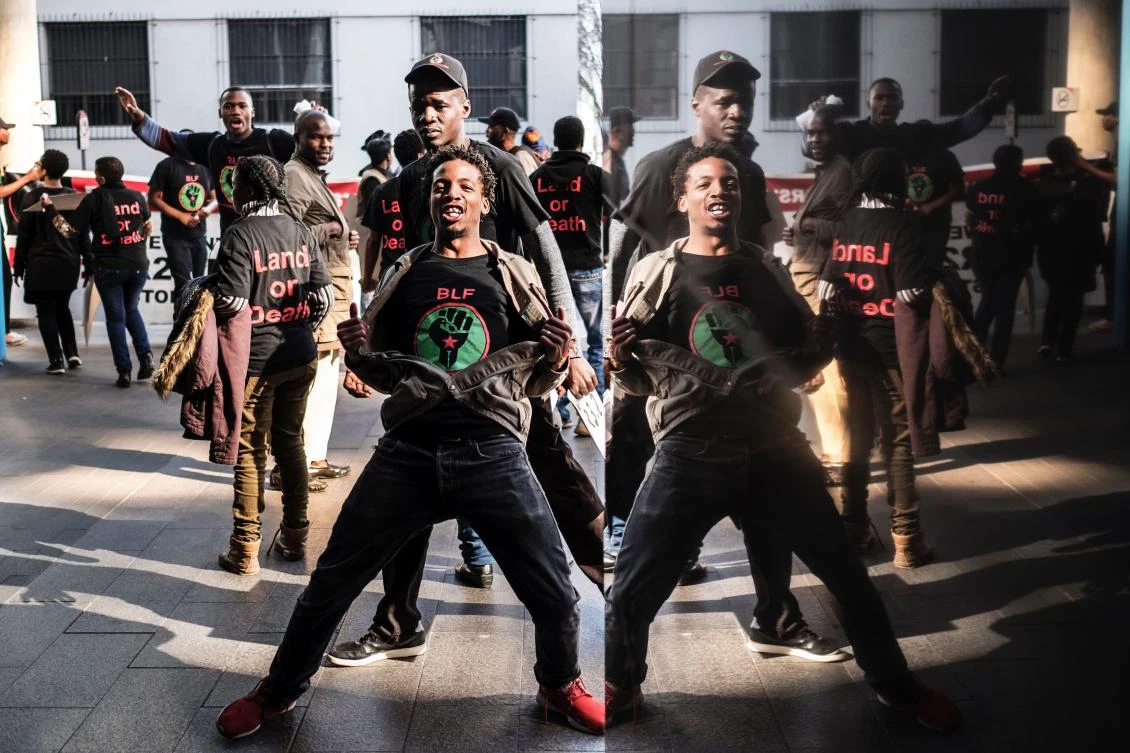 Activists demonstrate on on June 28, 2017 outside an Absa Bank branch in downtown Johannesburg, which has been accused of unduly benefiting from a Reserve Bank bail-out to the value of R1.125 billion. The Reserve Bank is also being criticized for its plan to print more money to reduce inflation, with critics warning such a move could trigger painful recession.. (AFP / MARCO LONGARI)
