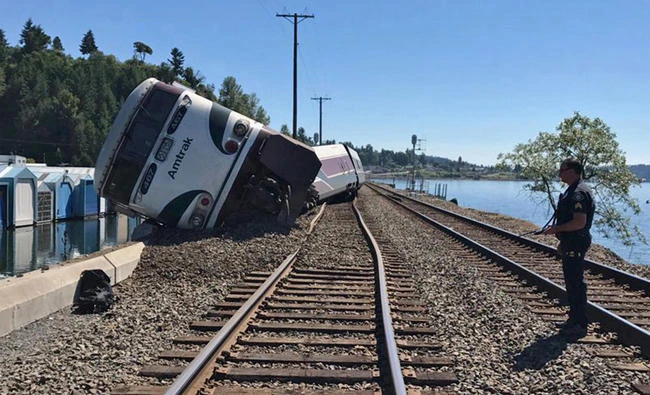 A derailed Amtrak passenger train lies on its side before the Chambers Bay Bridge on Puget Sound in Steilacoom, Washington, UN on Sunday. (West Pierce Fire Department/Handout via Reuters)