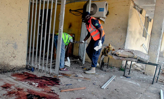 Emergency personnel are at work at the site of a blast at the campus of Maiduguri University and residential buildings. Nine people have been killed in a string of suicide attacks in Maiduguri, a city in Nigeria's restive northeast where Boko Haram Islamists began a deadly insurgency in 2009, police said. (AFP)