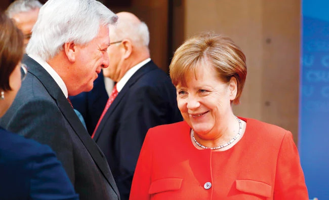 German Chancellor Angela Merkel with Hessen’s State Premier Volker Bouffier in Berlin on Monday. (AFP)