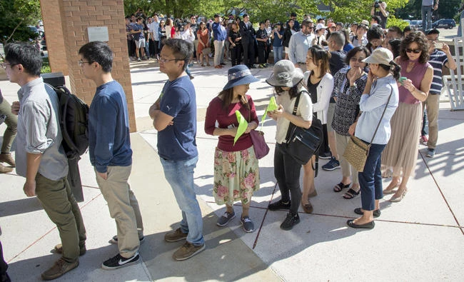 People line up outside the federal courthouse for first appearance of Brendt Christensen, the suspect in the kidnapping of Yingying Zhang, a Chinese scholar at the University of Illinois, on Monday in Urbana, Illinois. (Robin Scholz/The News-Gazette via AP)