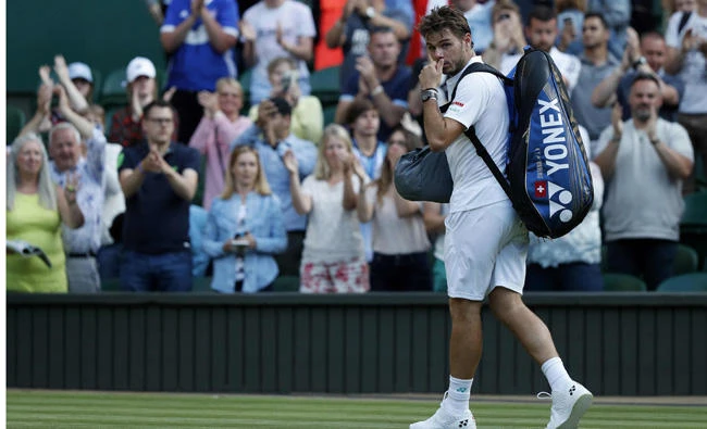 Switzerland's Stan Wawrinka leaves the court after losing to Russia's Daniil Medvedev during their men's singles first round match on the first day of the 2017 Wimbledon Championships at The All England Lawn Tennis Club in Wimbledon, London, on Monday. (AFP / Adrian Dennis)
