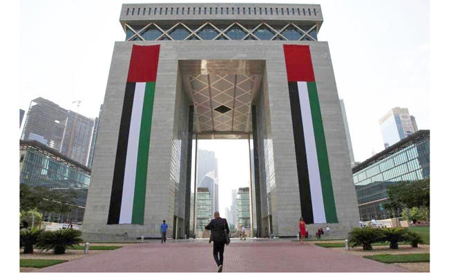 People walk outside the Gate Building at the Dubai International Financial Centre. (Reuters)