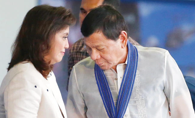 Philippine President Rodrigo Duterte and Vice-president Leni Robredo prepare to take their seats during the 70th anniversary celebrations of the Philippine Air Force near Manila. (AP)