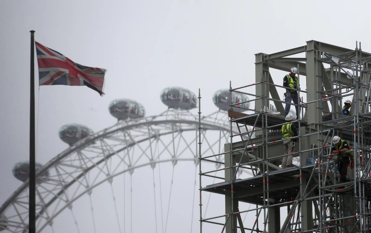 A Union Flag flies from a pole as workers construct a structure outside the Elizabeth Tower, commonly known as 'Big Ben', at the Houses of Parliament in Westminster, central London on June 28, 2017. (AFP)
