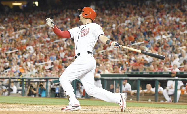 Ryan Raburn of the Washington Nationals sends home the winning run in the ninth inning during a baseball game against the New York Mets at Nationals Park on Monday in Washington, D.C. (AFP)