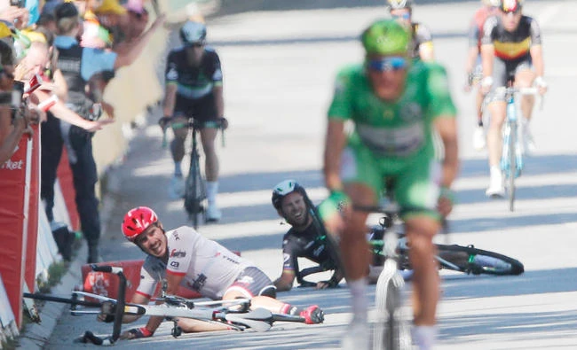 Germany's John Degenkolb, left, and Britain's Mark Cavendish crash during the sprint of the fourth stage of the Tour de France cycling race over 207.5 kilometers with the start in Mondorf-les-Bains, Luxembourg, and the finish in Vittel, France, Tuesday. (AP)