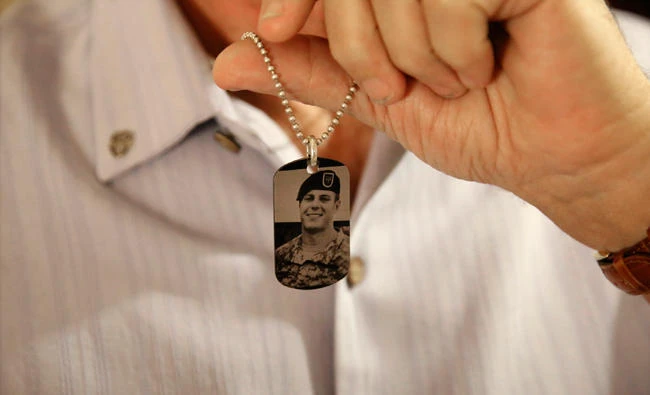 In this June 17, 2017 file photo, Brian McEnroe, the father of fallen U.S. Green Beret Kevin McEnroe, displays a memorial dog tag depicting his fallen son, in Amman, Jordan. First Sgt. Marik al-Tuwayha, the Jordanian soldier charged with killing three U.S. Army Green Berets including McEnroe, in November 2016, told a military court Tuesday, July 4, 2017, that he opened fire because he thought fellow Jordanian troops had come under attack. (AP)
