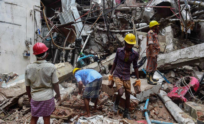 Bangladeshi workers take part in a search and rescue operation at a destroyed garment factory in Gazipur on July 4, 2017, after a boiler explosion at the complex on the outskirts of Dhaka. (AFP)