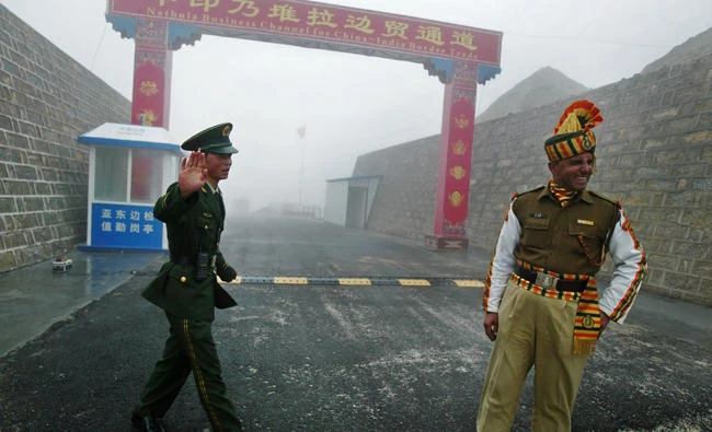 A Chinese soldier, left, next to an Indian soldier at the Nathu La border crossing in India's northeastern Sikkim state, in this file photo. (AFP)