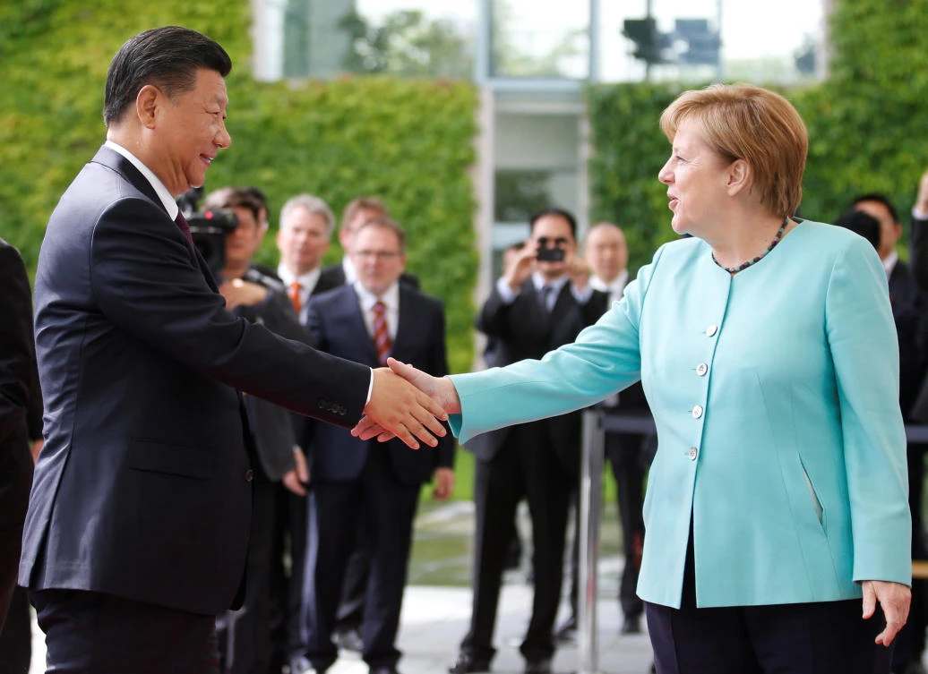German Chancellor Angela Merkel welcomes Chinese President Xi Jinping in Berlin on Wednesday. (Reuters)