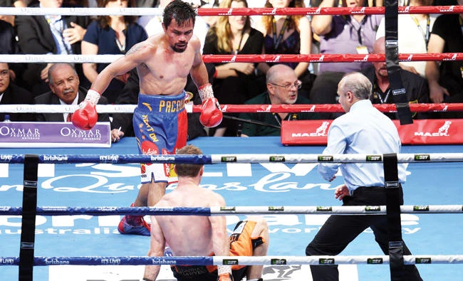 Manny Pacquiao of the Philippines watches as Jeff Horn of Australia hits the canvas. (Reuters)