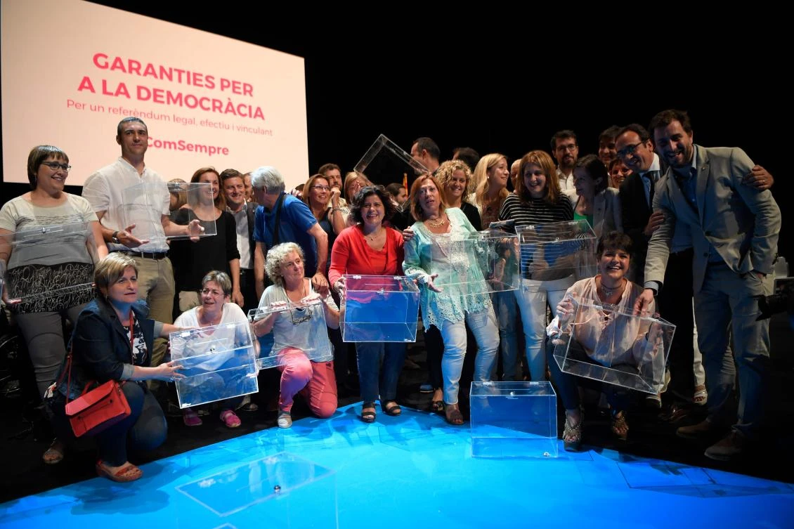 Deputies of the Catalan Parliament pose with ballot boxes after the presentation of the details of the Oct. 1 referendum, in Barcelona on Tuesday. (AFP)