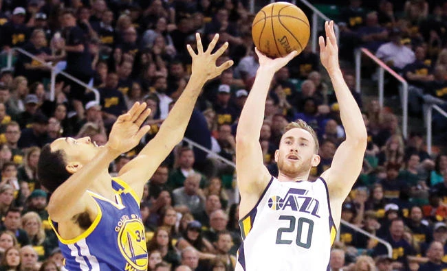 In this May 6 file photo, Utah Jazz forward Gordon Hayward (20) shoots as Golden State Warriors guard Shaun Livingston defends in the second half during Game 3 of the NBA basketball second-round playoff series in Salt Lake City. Hayward has chosen to sign with the Boston Celtics and reunite with coach Brad Stevens, making the announcement Tuesday evening on The Players’ Tribune site. (AP)