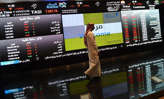 A Saudi investor monitors the stock exchange at the Saudi Stock Exchange. (AFP file)