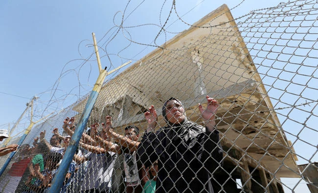 Palestinians gather in front of the gate of Rafah border crossing between Egypt and Gaza during a protest in the southern Gaza Strip. (Reuters)