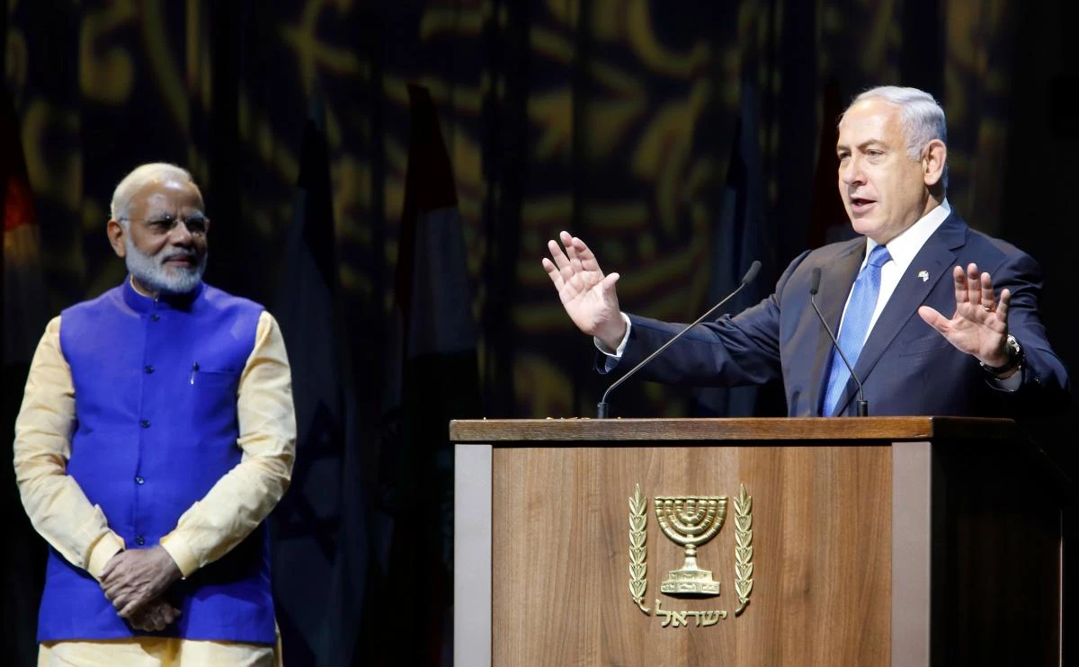 Israeli Prime Minister Benjamin Netanyahu (R) greets his Indian counterpart Narendra Modi during a meeting with Indian community in the Israeli coastal city of Tel Aviv, on July 5, 2017. Prime Minister Narendra Modi arrived in Israel for what he called a "groundbreaking" first ever visit by an Indian premier, with growing ties between the two countries including billion of dollars in defence deals. (AFP)