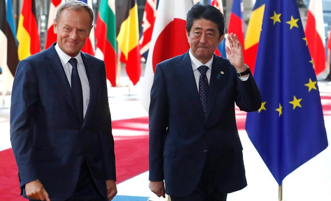Japan's Prime Minister Shinzo Abe, right, is welcomed by European Council President Donald Tusk. (Reuters)