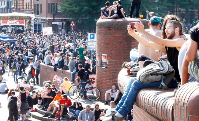 A demonstrator takes a selfie as he waits for a protest against the G-20 Summit in Hamburg, northern Germany. (AP)