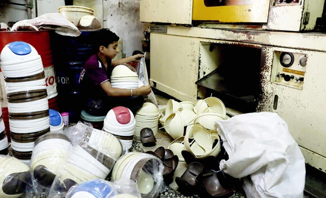 A Syrian child works in a plastic factory in Aleppo’s Al-Kalasseh area. (AFP)