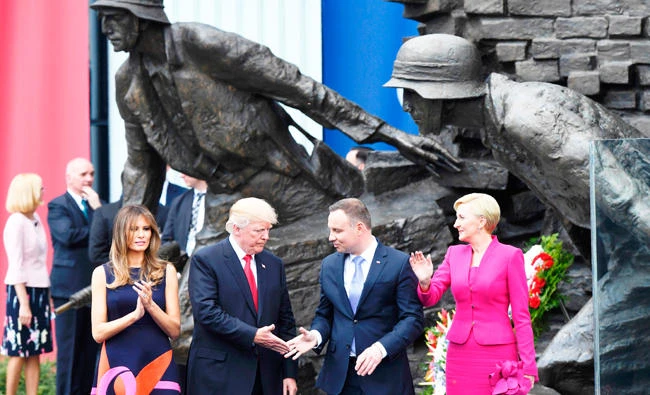 US President Donald Trump, 2nd left, his wife Melania Trump, left, and the Polish President Andrzej Duda and his wife Agata Kornhauser-Duda, right, stand in front of the Warsaw Uprising Monument on Krasinski Square after Donald Trump gave a speech during the Three Seas Initiative Summit in Warsaw, on Thursday. (AFP)