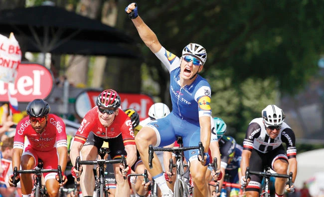 Germany's sprinter Marcel Kittel celebrates next to Germany's Andre Greipel, center left, as he crosses the finish line to win the sixth stage of the Tour de France cycling race over 216km (134 miles) with start in Vesoul and finish in Troyes, France, Thursday. (AP)