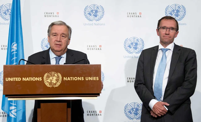 This handout picture provided by United Nations shows Secretary-General Antonio Guterres (L) speaking next to Special Adviser of the UN Secretary-General on Cyprus, Norvegian Espen Barth Eide, during a press conference closing peace talks in the Swiss resort of Crans-Montana on early Friday. (AFP PHOTO / United Nations)