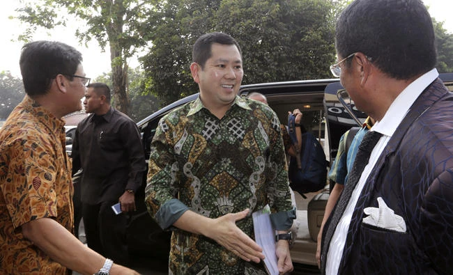 Media Nusantara Citra (MNC) Group President and CEO Hary Tanoesoedibjo, center, arrives at the national police's Criminal Investigation Agency in central Jakarta, Indonesia, on Friday. (AP Photo/Tatan Syuflana)