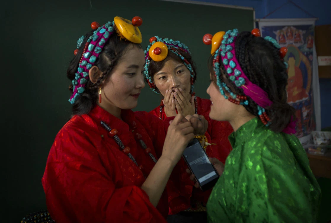 Exiled Tibetans women prepare for a dance performance during celebrations marking the 82nd birthday of Dalai Lama in New Delhi on Thursday. (AP)