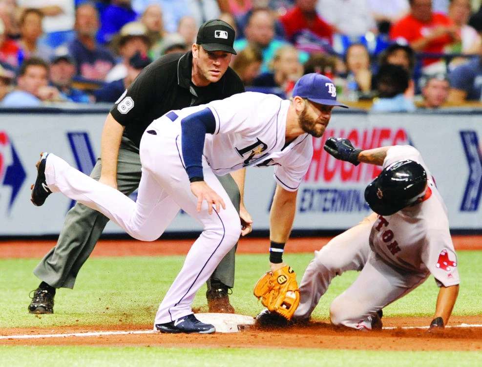 Umpire Chris Conroy, left, watches as Tampa Bay Rays' Evan Longoria, middle, tags out Boston Red Sox's Tzu-Wei Lin on a throw from catcher Wilson Ramos during the fifth inning of a baseball game in St. Petersburg on Thursday. (AP)
