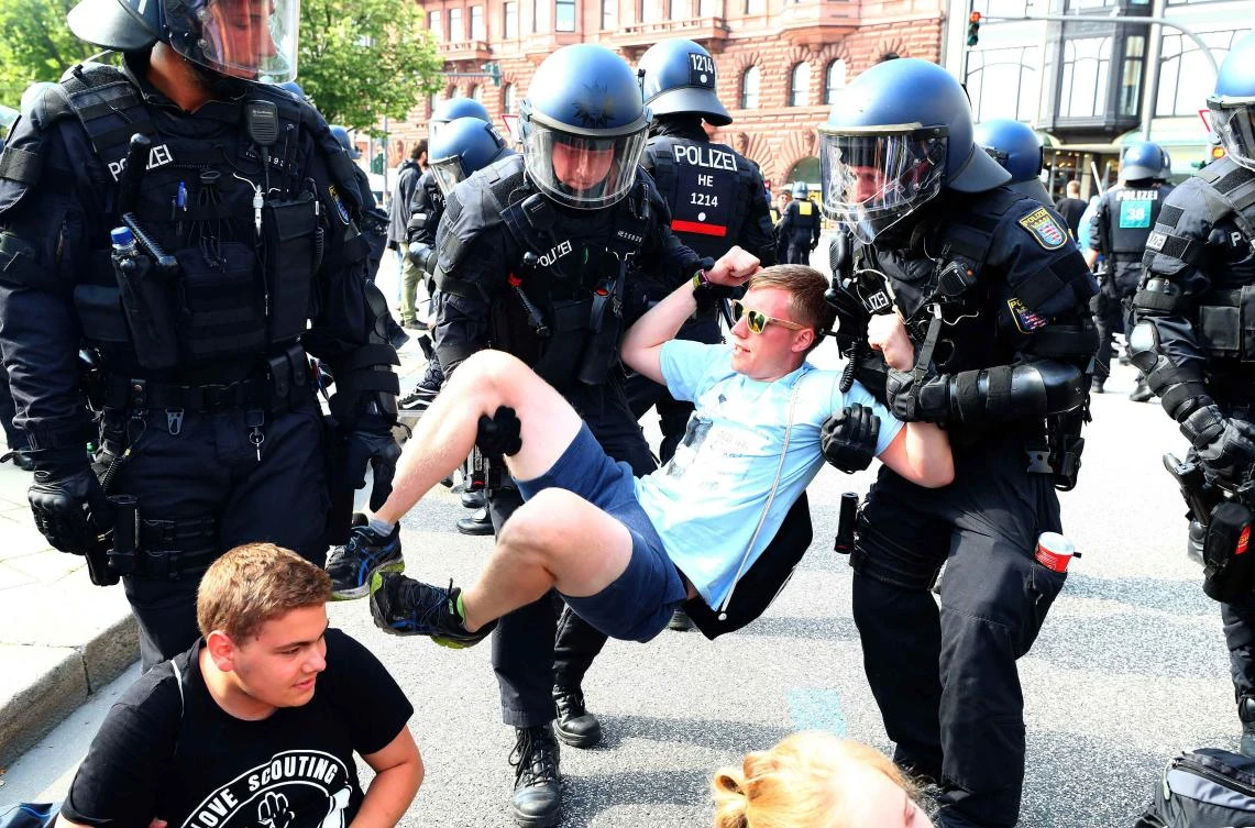German police remove protestors who are blocking a street at a demonstration during the G20 summit in Hamburg, Germany, July 7, 2017. REUTERS/Pawel Kopczynski