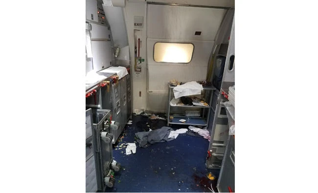 This July 7, 2017 photo taken by the FBI shows the aftermath of a cabin on Delta Flight 129 from Seattle to Beijing, after authorities say flight attendants struggled with Joseph Daniel Hudek IV, a passenger who lunged for an exit door. (FBI via US Attorney's Office in Seattle via AP)