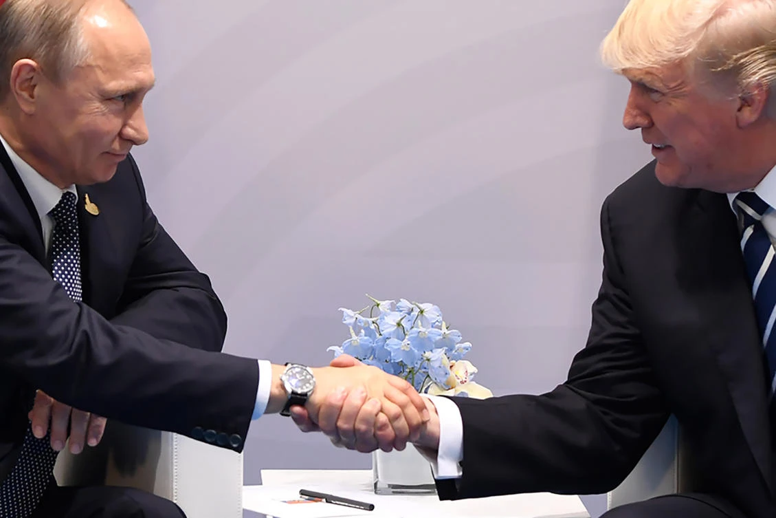 TOPSHOT — US President Donald Trump and Russia’s President Vladimir Putin shake hands during a meeting on the sidelines of the G20 Summit in Hamburg, Germany, on July 7, 2017. (AFP)