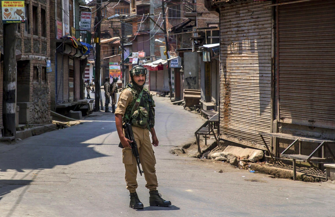 An Indian paramilitary soldier stands guard on a deserted street in Srinagar, Indian controlled Kashmir, Friday, July 7, 2017. Government forces imposed curfew-like restrictions in many parts of Indian controlled Kashmir to stop anti Indian protests ahead of the first death anniversary of rebel leader Burhan Wani on Saturday. His killing by security forces last year sparked violent street clashes and almost daily protests throughout the region. (AP)