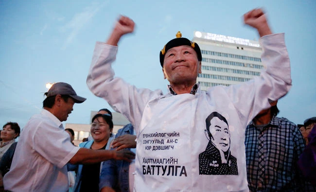 People celebrate after populist former martial arts star and businessman Khaltmaa Battulga won Mongolia's presidential run-off election, in Ulaanbaatar, Mongolia on Saturday. (REUTERS)