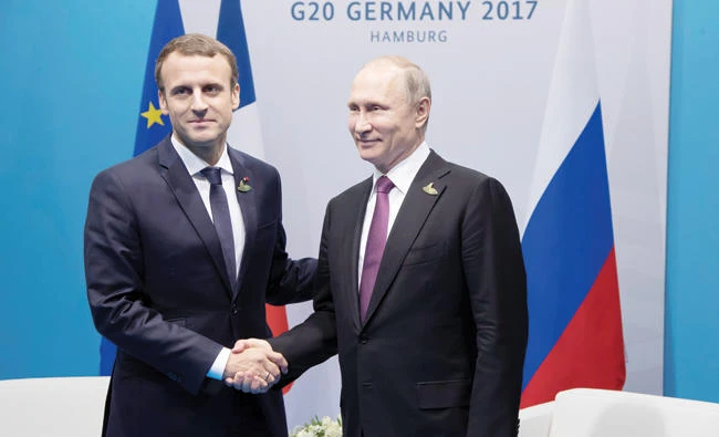 French President Emmanuel Macron withRussian President Vladimir Putin at the G-20 Summit in Hamburg, Germany. (Reuters)
