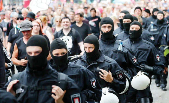 German police walk in line as they secure a demonstration during the G-20 Summit in Hamburg, Germany. (Reuters)