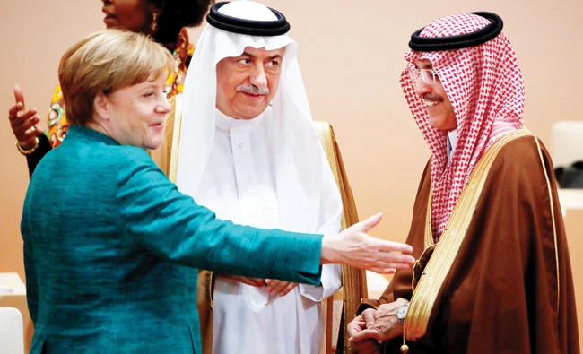 German Chancellor Angela Merkel with Saudi Finance Minister Mohammed Al-Jadaan andIbrahim Al-Assaf, minister of state and Cabinet member, at the G-20 Summit in Hamburg, Germany. (Reuters)