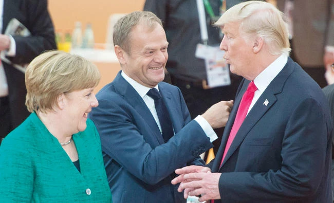 US President Donald Trump with German Chancellor Angela Merkel and European Council President Donald Tusk at the G20 Summit Saturday in Hamburg, Germany. (AP)