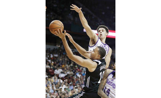 Los Angeles Lakers' Lonzo Ball, top, guards Los Angeles Clippers' Brice Johnson during the first half of an NBA summer league basketball game Friday in Las Vegas. (AP)